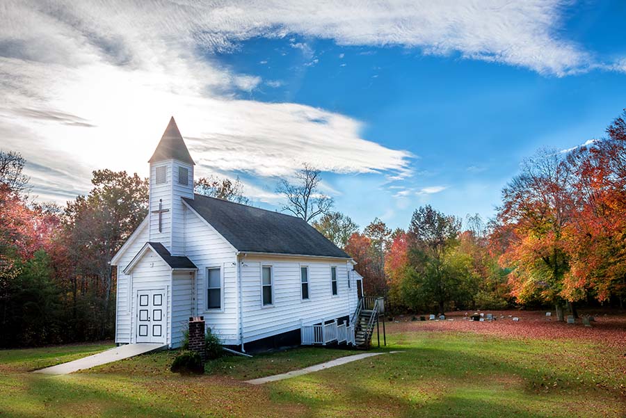Specialized Business Insurance - Colorful View of a Small Traditional White Church in the Countryside Surrounded by Colorful Fall Foliage